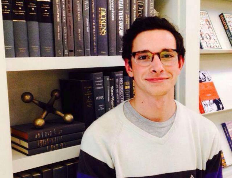 Junior Anthony Mauriello poses in front of a bookcase at The Warby Parker store in San Francisco.  Courtesy of Anthony Mauriello.