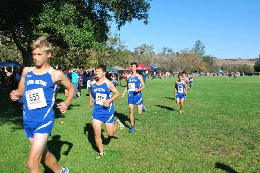 A stream of boys runners jog in a competition. The cross country team has been stressing a team mentality this season. Photo Courtesy Brian Wang