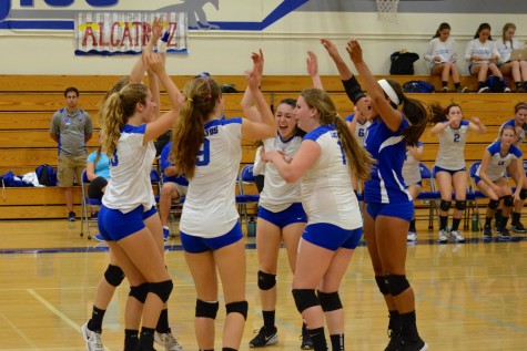 The girls volleyball team celebrates an ace. Despite losing many of their leaders to graduation and injury, the Eagles came together to win their second straight Golden Gate Classic. Photo by Kunal Pandit.