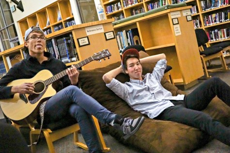 Viktor Niemiec (left) and Derek Mark (right) pose for the camera in the library. Photo by Michael Sieffert. 