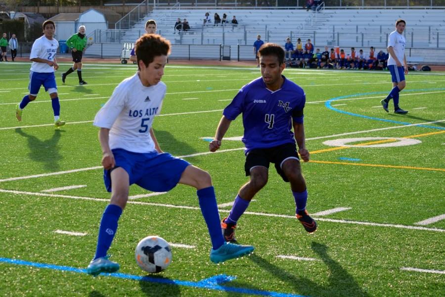 Junior Edwin Hernandez dribbles the ball past a defender. Photo by Kunal Pandit.