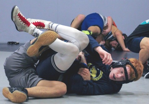 unior Joey Donnelly attempts an escape. The wrestling team is off to a strong start, combining experience and youth. Photos by Michael Sieffert.