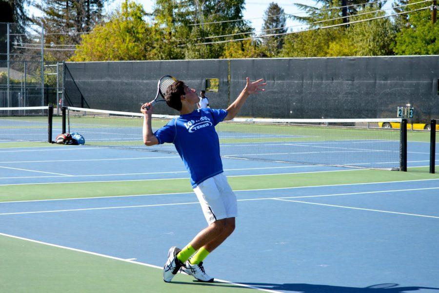 Junior Alec Jenab winds up to serve in practice. Despite a few tough losses, the boys tennis team boasts a 7-4 record and has SCVAL championships in its sights. Photo by Kunal Pandit.
