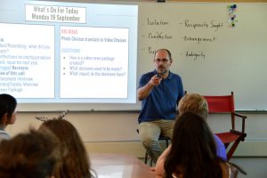 English teacher Robert Barker teaches the New Media Literacy class to students in room 401. Photo by Katie Klein.