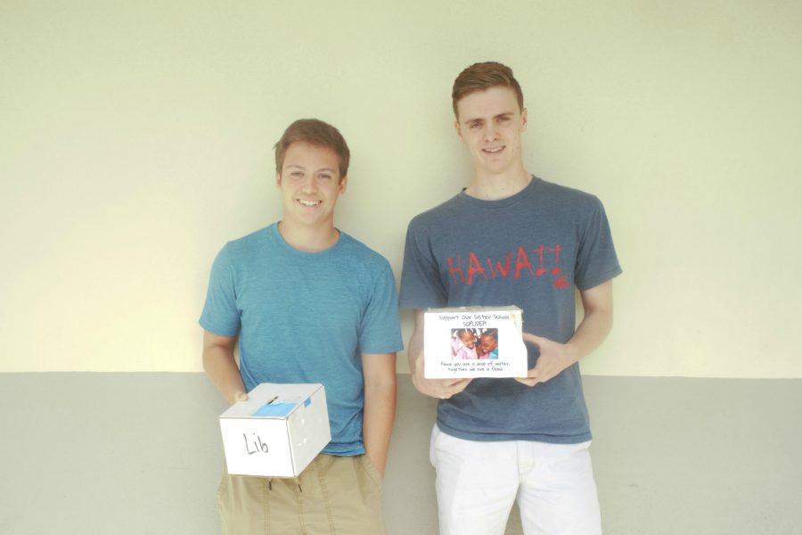 Club co-president seniors Ben Carter (left) and Duncan Drewry pose with their donation boxes. Photo by Yolanda Spura.