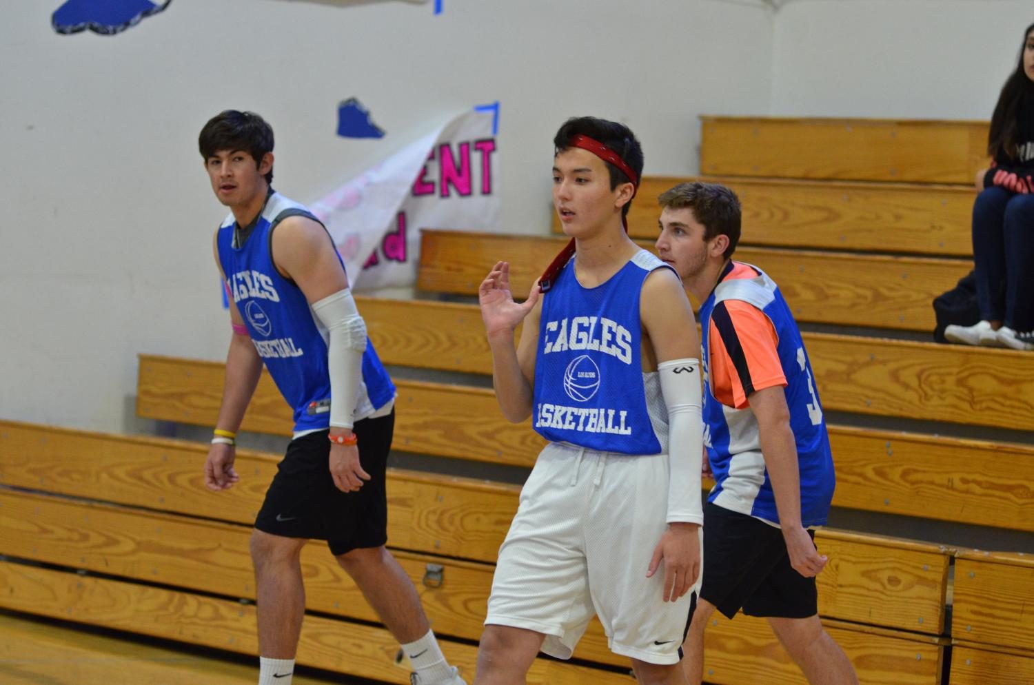Catch U Outside’s junior Zach Murphy (front), senior Kai Jarmon (back left) and senior Max Sullivan (back right) wait for the opening whistle against the Cougars in quarterfinals.