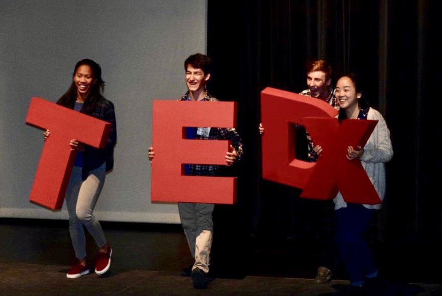 After cleaning up for the first-ever TEDxLosAltosHigh, four juniors (left to right: Julia Santos, Emilio Sanchez-Harris, Eric Warmoth and Lisa Deng) hold up the TEDx letters. While the event received low attendance, audience members and speakers alike believe in its importance in future years. Photo courtesy Line Amalie Christensenf.