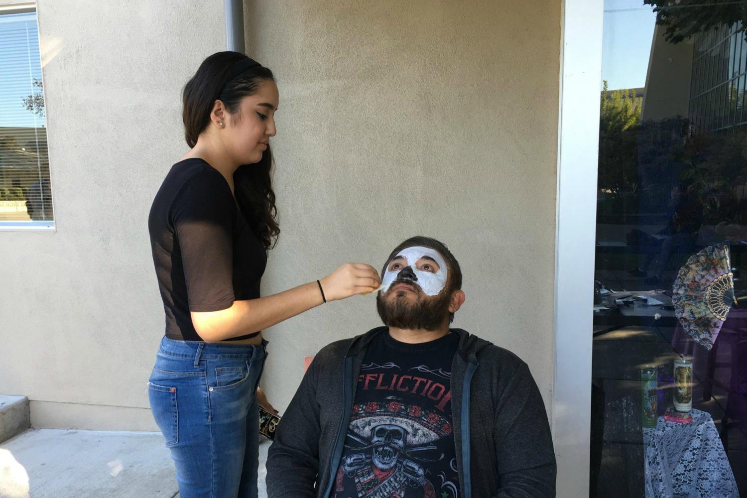 Jessica Vera, designer of this years Homecoming shirt, brought her skills to the work of face painting to help celebrate Dia de Los Muertos this past fall. Now, shes set to paint faces at tomorrows Cinco de Mayo celebration.