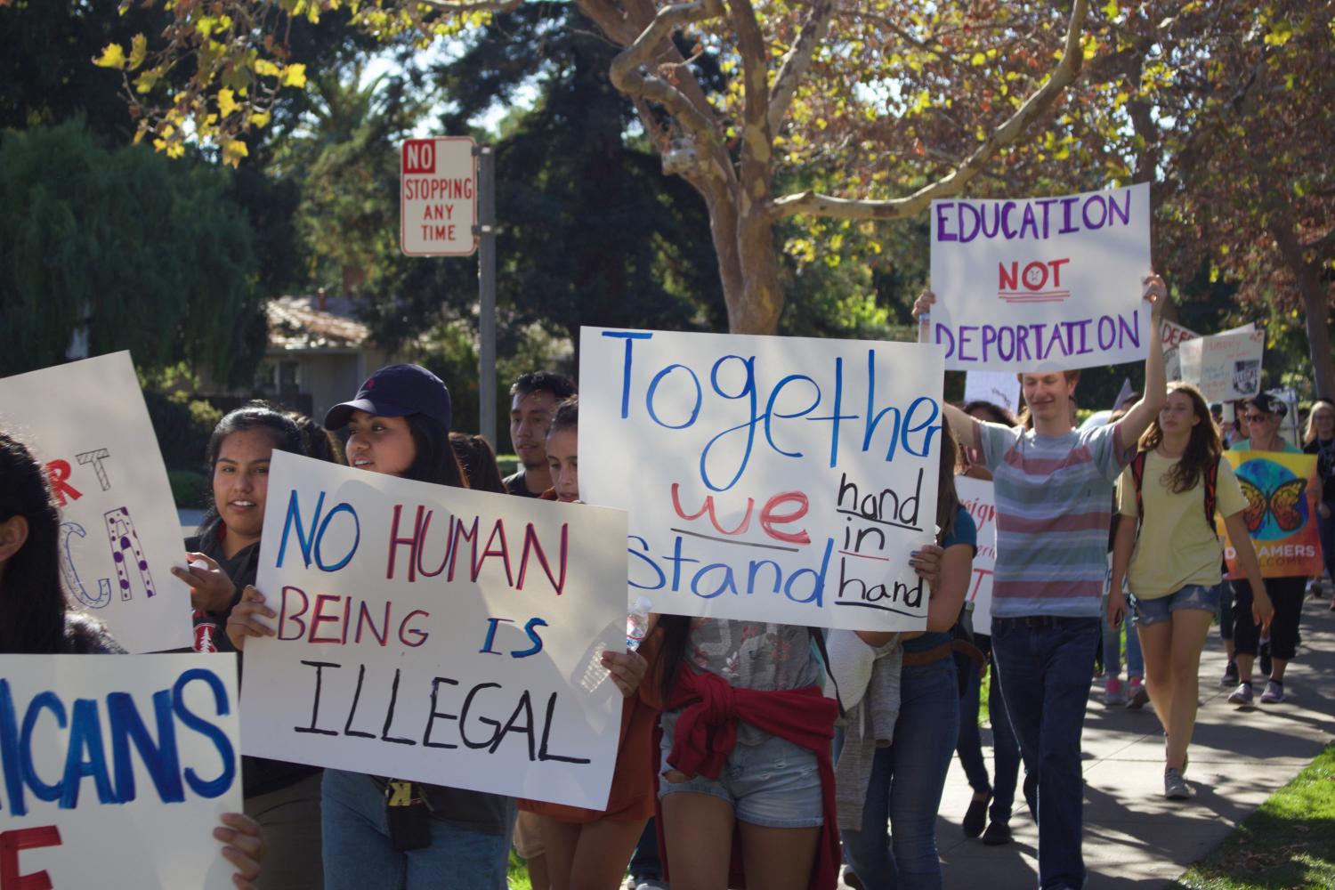 Students held signs and chanted as they marched to Eagle Park in Tuesday's protest of the DACA repeal.