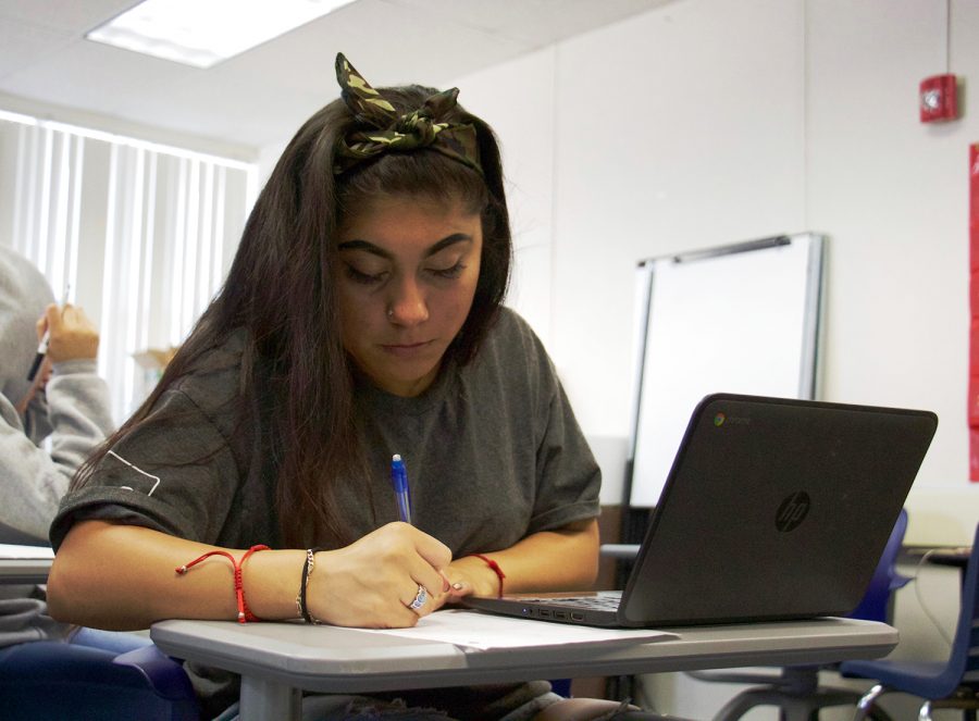 Senior Cristal Acevedo Erostico works on a math problem in Essential Math Concepts. The individually paced course, designed to prepare students for the placement exams required by junior colleges, also incorporates lessons on resiliency and financial literacy into its curriculum. Katrina Arsky.