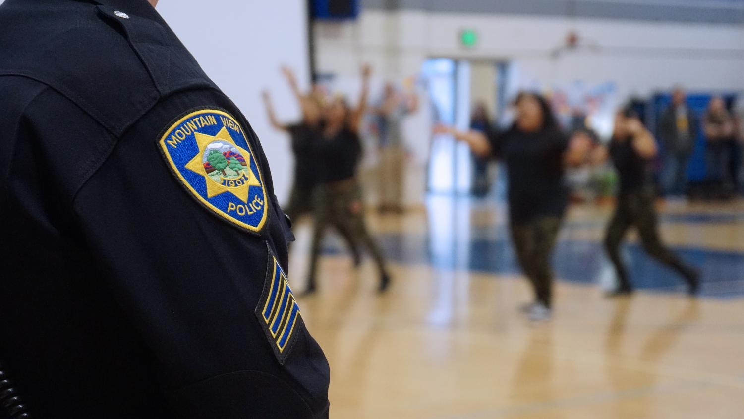 A Mountain View police officer watches over this morning's Diversity Assembly, which proceeded without incidence. Police increased their presence around Los Altos following a potential threat to the assembly. Kylie Akiyama.