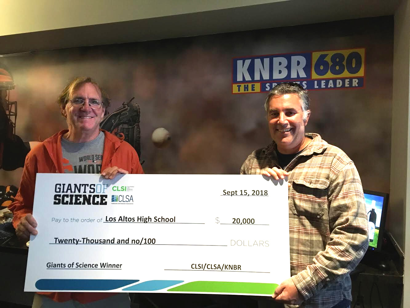 Environmental science teacher Greg Stoehr and biology teacher Jacob Russo hold the winning grant check for the Giants of Science competition. The money will go to fund Stoehr’s bioprospecting project. Darren Dressen.