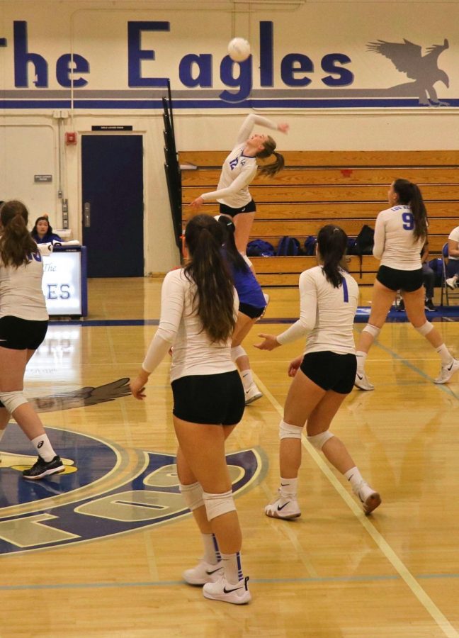 Sophmore Naomi Cremoux spikes the ball in a 3-1 win against Chico High school. After learning about the fire that threatened the homes of several on the Chico team, the girls varsity volleyball team decided to hold a fundraiser for Chico citizens at their next NorCal game.