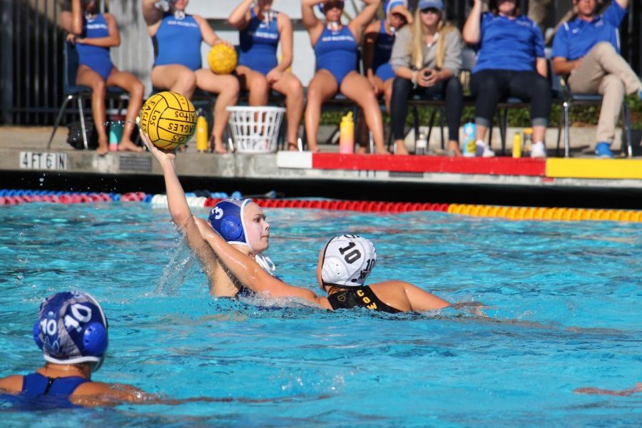 Junior Olivia Cairns looks for a pass at the Eagles game against rival Mountain View. The girls water polo team lost 7-12, and they face Mountain View again this Saturday for CCS Championships.