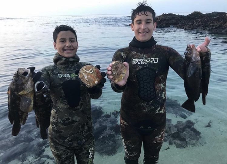 Noah Revelo (on the right) takes his little brother spearfishing for the first time to pass down the family tradition.