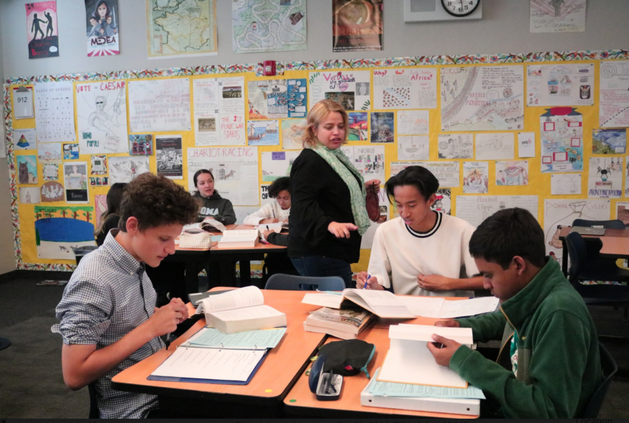 Latin teacher Krista Greksouk helps sophomore Ceasar Palting as the students decipher texts together.