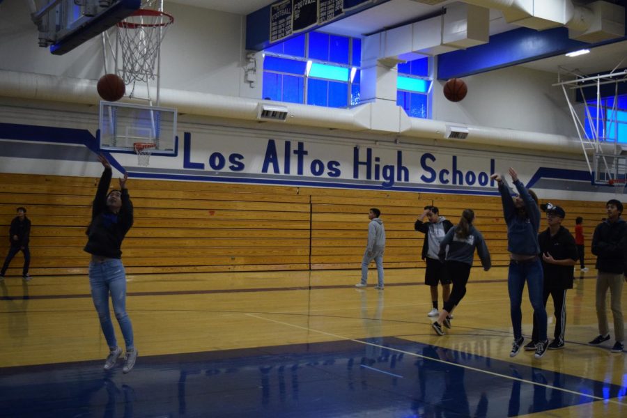 Senior Nicole Player joins the game to show her spirit and bring together the community as she competes against junior Jocelyn Lee for a critical shot. FCA aims to create a safe space where students can explore ways to bring their faith and life as an athlete together.