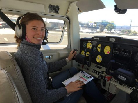 Senior Kate Koralevskaya sits in the cockpit of a plane at San Carlos Airport awaiting the beginning of her flight training. Many of the flight instruments are covered with emoji stickers to ensure focus on her surroundings. Over the summer, she learned how to fly and obtained her private pilot’s license through the Upwind Scholarship.