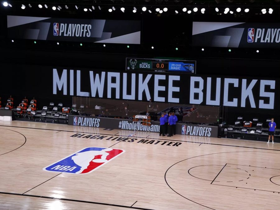 Referees gather together after the Milwaukee Bucks refuse to take the court against the Orlando Magic. After numerous games were canceled following the police shooting of Jacob Blake, a Black man in Kenosha, Wis., the NBA and NBPA talked with players and staff and released a joint statement announcing that teams would continue playing playoff games on Saturday, September 29.