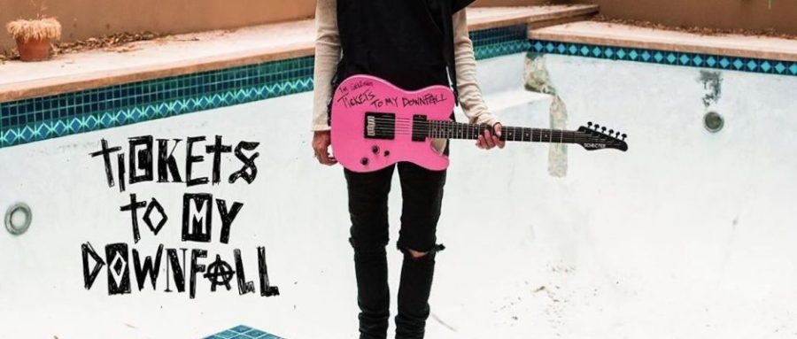 The cover for Machine Gun Kelly’s “Tickets To My Downfall” features him standing at the edge of an empty pool with a bright-pink guitar. “Tickets To My Downfall” explores pop punk, a departure from MGK’s previous rap albums.