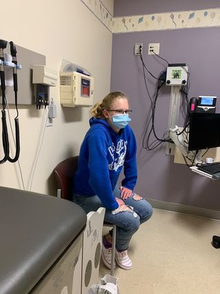 Senior Cathryn Krajewski sits in a general exam room at the Kaiser Santa Clara Medical Center listening to a nurse go over procedural paperwork. Cathryn is a participant in Pfizer’s first COVID-19 vaccine trial for minors, documenting the journey in the hopes of illuminating the reality of vaccination for her community.