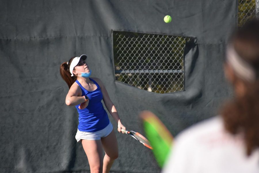 Junior Sofia Mujica completes a serve in a doubles match against Mountain View. In their closest match of the season, the varsity girls tennis team beat tough rival Mountain View 4-3.