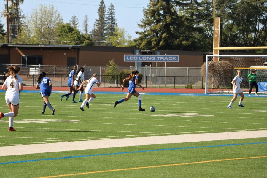 Co-Captain junior Esha Gupta runs on a hurt knee, dribbling the ball upfield past MVHS defenders. The varsity girls soccer team ultimately lost 4–0, in a disappointing repeat of the last rivalry game.