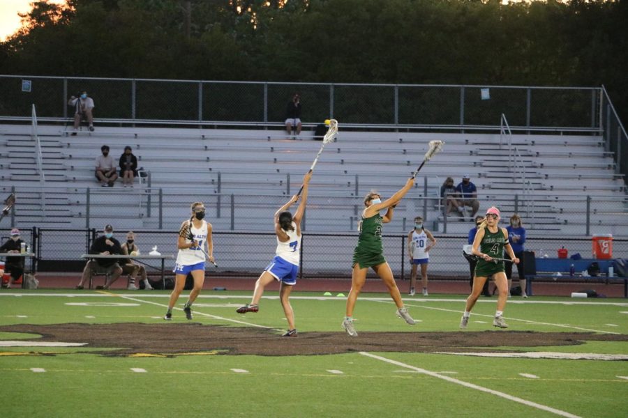 Junior Diya Gupta reaches to catch the ball ahead of a Palo Alto High School defender. The Eagles lost to Paly 17–0 but went on to win their next game against Wilcox High School 14–5.