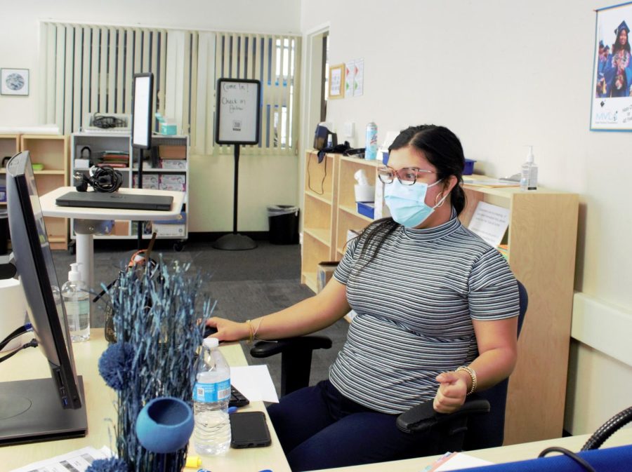 New Tutorial Center Coordinator Esmeralda Paredes sits at her desk as she supervises students. 