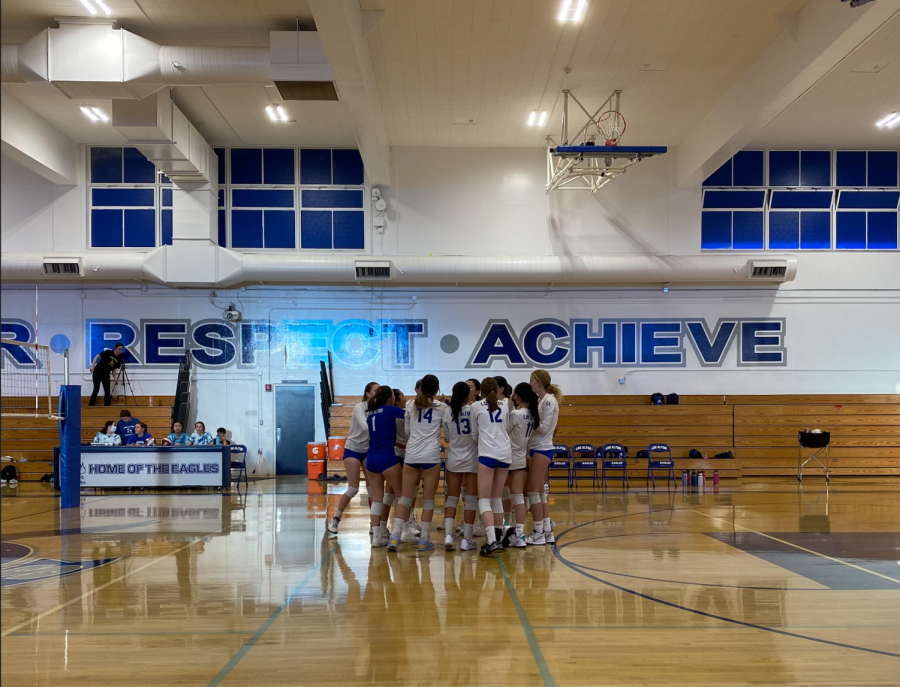 The Los Altos varsity team huddles for a cheer before the game starts. The Eagles scored a 3-0 win.