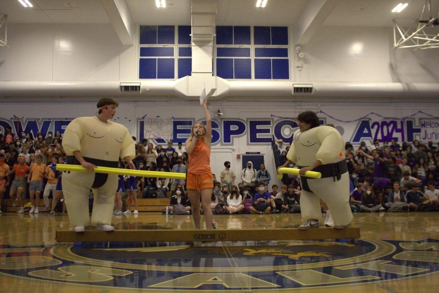 Students are participating in a game planned by ASB during the back-to-school rally. ASB introduced this game as sumo and it is being played with inflatable sumo suits, pool noodles and a balance beam.