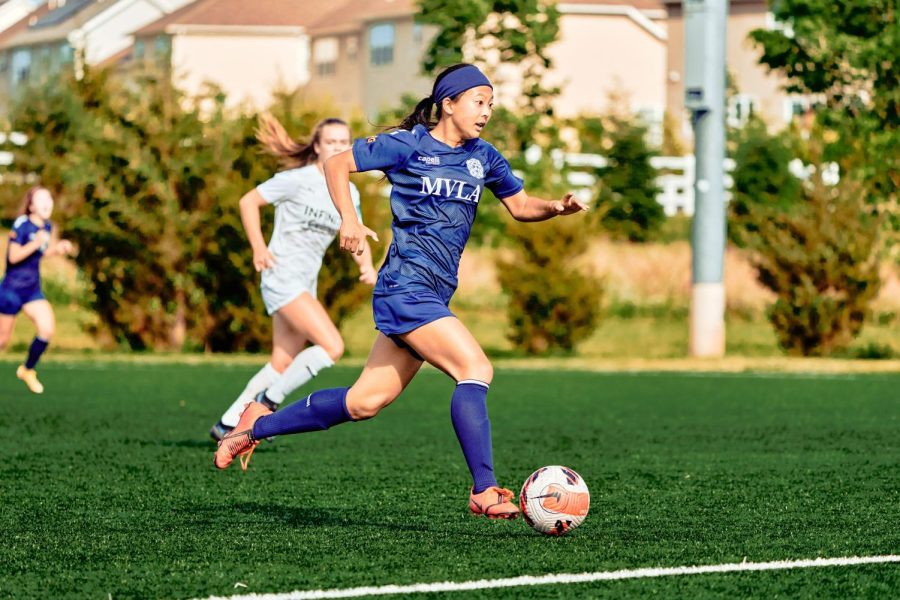 Junior Sophia Kurisu dribbles a soccer ball across the field during a game for the Mountain View-Los Altos soccer team. Last summer, Sophia joined the NorCal Premier team, which won the Gothia Cup U-17 division.