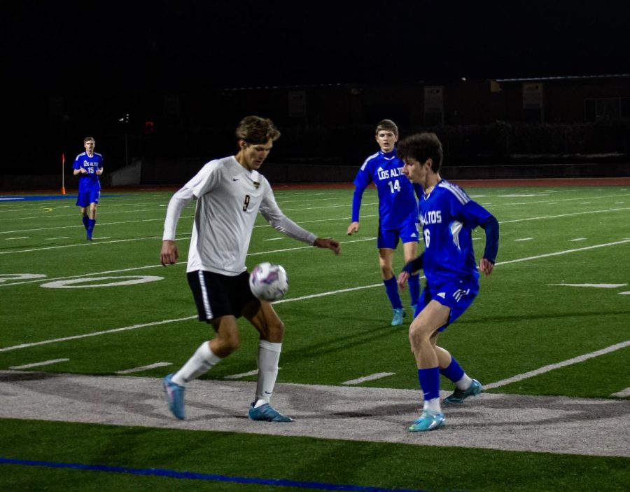 The Los Altos High School varsity boys soccer team defends a Mountain View High School player.