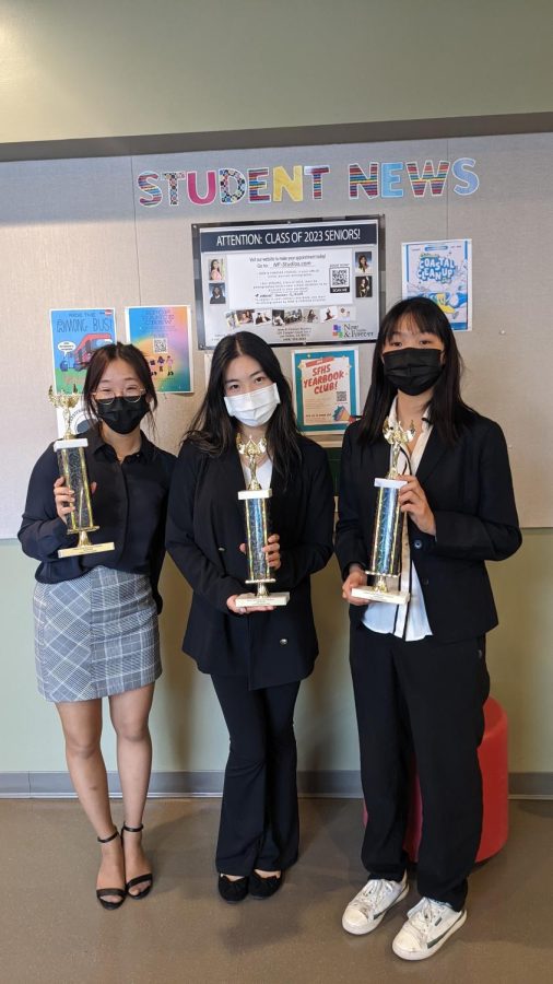 Three debaters hold trophies at the Robert Garcia Memorial Invitational. From left to right: Grace Chang, Evelyn Chao, Bridget Liu.