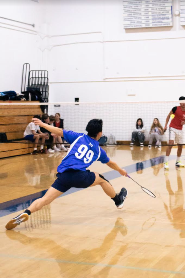 Varsity badminton team captain junior Ben Xu stretches for another extraordinary defensive move.  Following two losses, the team defeats Santa Clara High School 30–0, recording 1–2 overall.