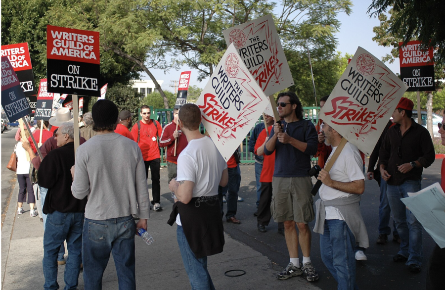 Protestors rally the streets, carrying signs in solidarity for their fellow writers and directors.