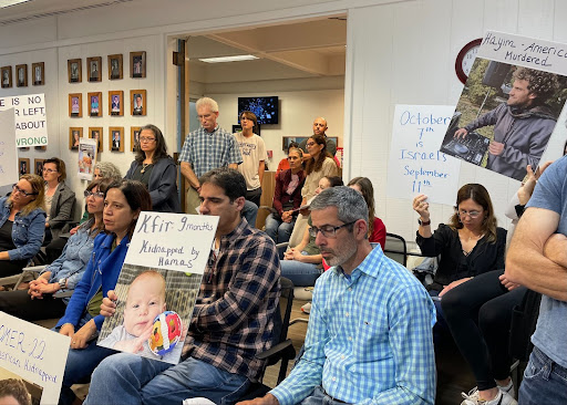 Families at the MVLA Board meeting on October 16 hold up signs in support of those affected by recent Hamas attacks, many of whom are friends or loved ones.