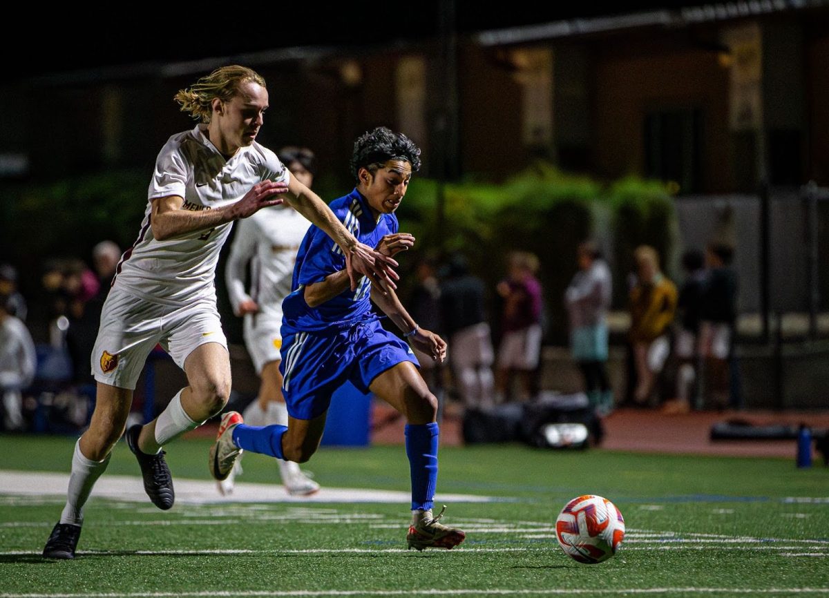 Junior Kapil Jakatdar runs to beat a Menlo-Atherton defender to the ball during the second half of their game against Menlo-Atherton High School.