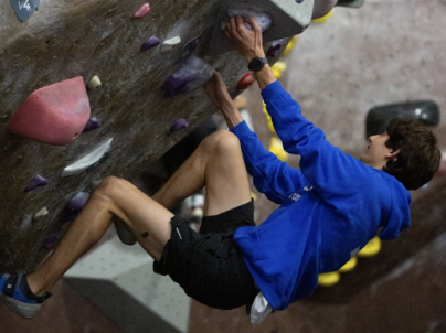 Junior Armon Moghbel scaling a climbing wall at Movement Sunnyvale. The climbing club visits the rock climbing gym to allow its members to experience the sport and climb with friends.