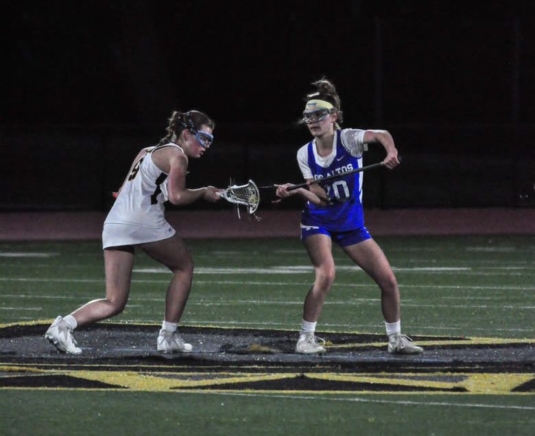 Junior Loala Bacchi fights for the ball. On Wednesday, March 13, the Los Altos High School varsity girls lacrosse team won its rivalry game against Mountain View High School 12–7 at home.