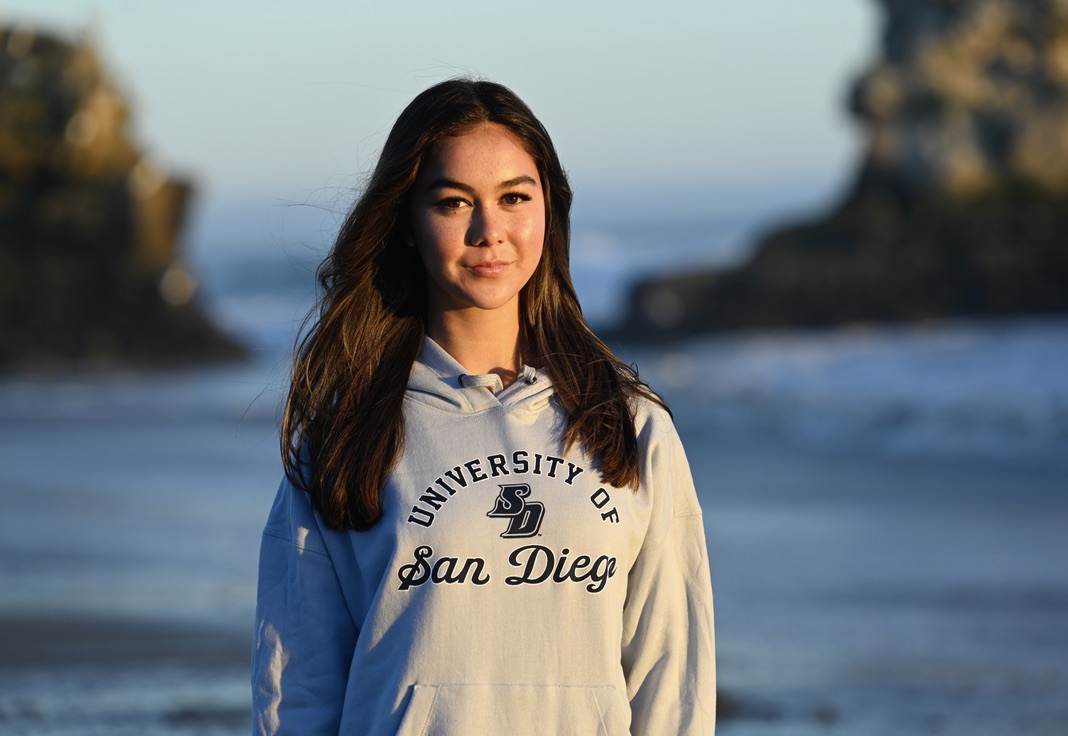 Senior Michaela Jones poses in University of San Diego gear. In late 2023, Michaela committed to USD for Division I rowing.