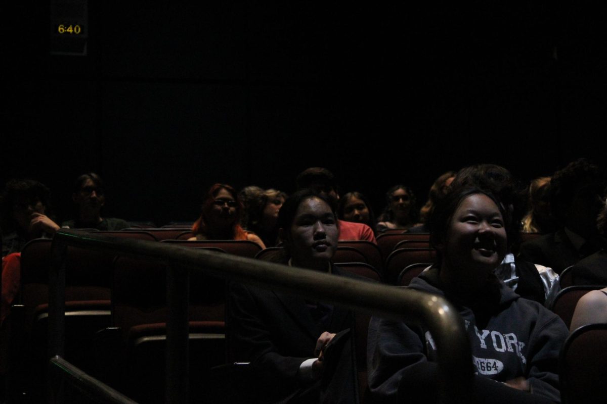 Seniors Matthew Peng and Lily Wride, both Film Analysis students with films in the festival, watch the introduction.