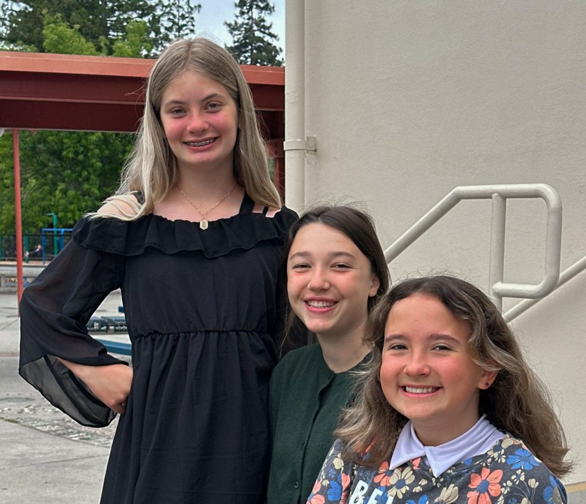 From left to right: Almond Elementary School sixth graders Bailey Bordo, Maya Stern and Chloe Renz sit together outside Almond. 