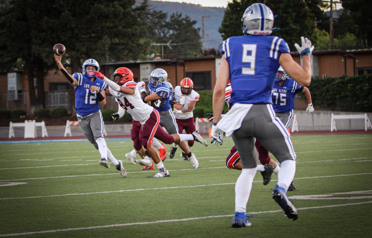 Sophomore Giancarlo Mendoza passes down the line to senior Colton Caputo. 