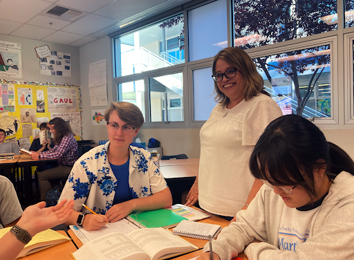 Students work on translating Latin phrases while Latin teacher Krista Greksouk answers their questions.