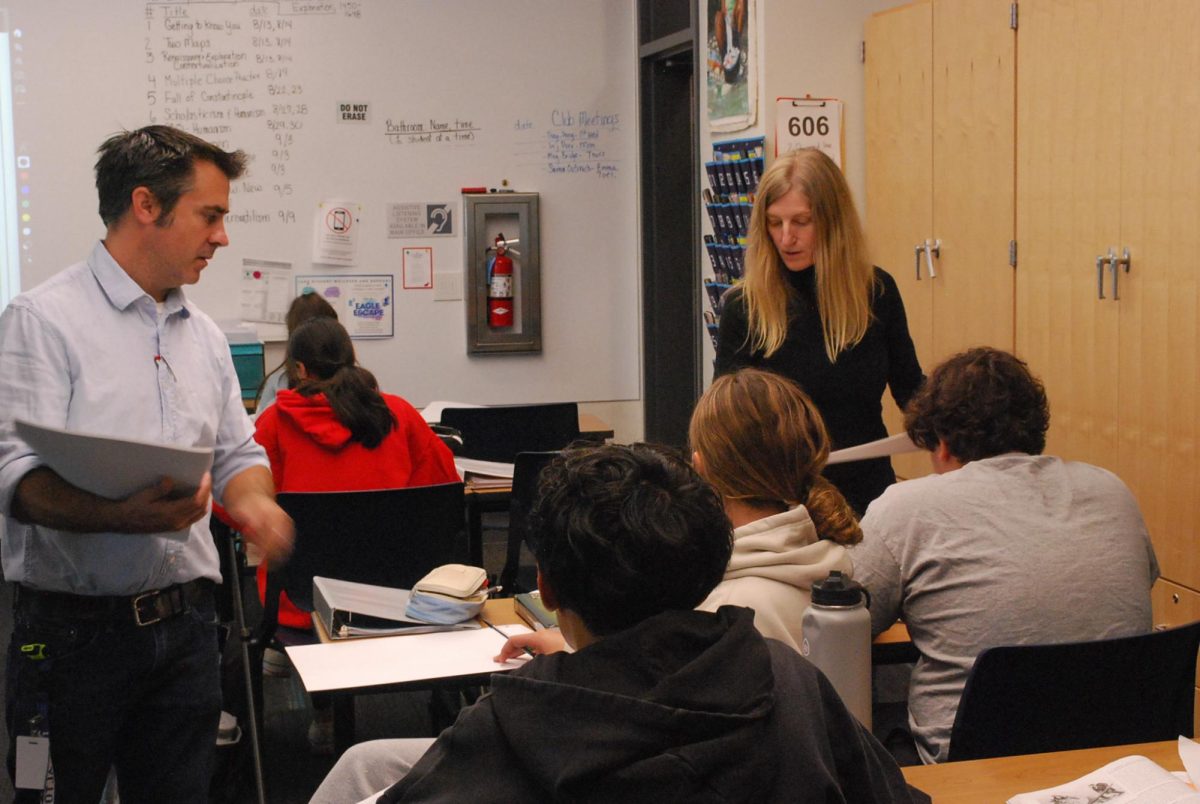 US History co-teachers Christa Wemmer and Stefaan Lodge helping students during a lecture.