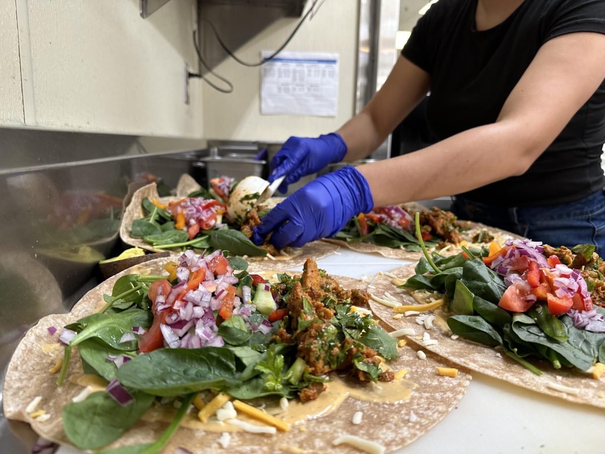 Cafeteria chefs make burritos in the morning in preparation for lunch. Here is an inside scoop about larger pizza supplies and what goes on inside the cafeteria.