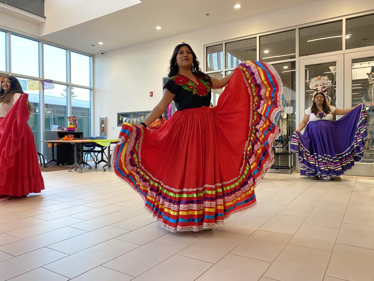 LSU dance coordinator senior Yocelin Rojas dances La Bruja along with the other members of LSU Dance while wearing traditional Jalisco dresses and balancing candles on their heads.