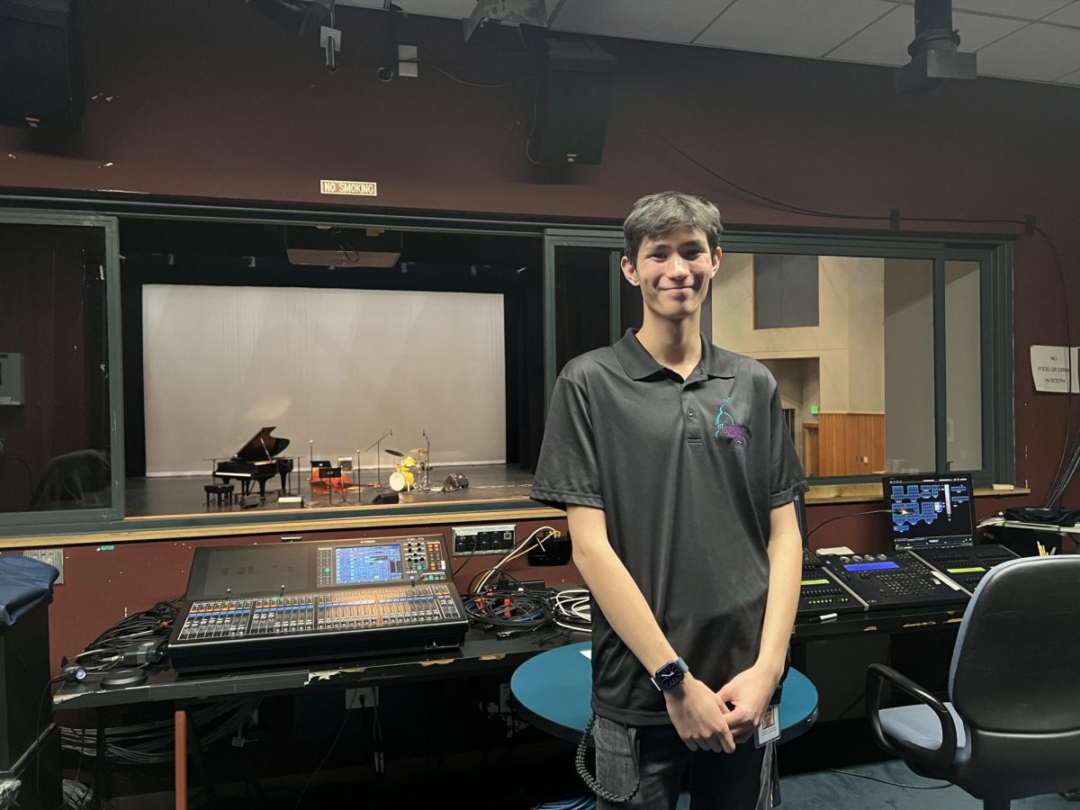 Nathan Coleman, owner and founder of company “Blackout Lighting” poses in the tech booth at the Los Altos High School Theatre.