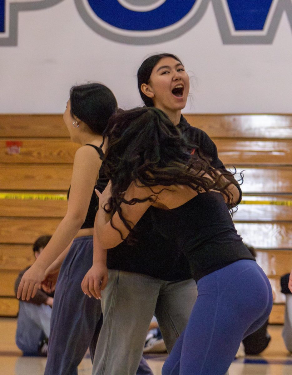 Junior Anastasia Marinopoulos revels in her point victory during the annual ASB volleyball tournament that took place from Tuesday, December 3 to Friday, December 6.